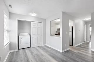 A white fridge and freezer in a room with wooden floors and white walls at Parkview of Lebanon Apartments, Lebanon, IN, 46052