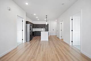 A kitchen with a white island in the middle of the room.