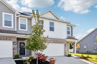 A modern two-story house with a garage and a driveway.