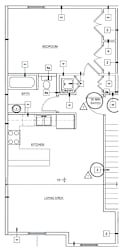 A floor plan of a small apartment with a bedroom, living area, and kitchen.