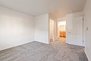 A room with a carpeted floor and white walls.