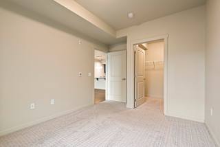 A room with a white door and a white closet.