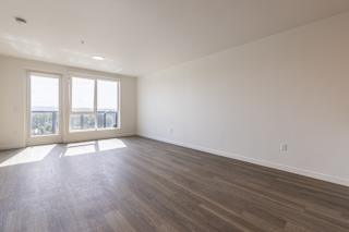 A room with wooden floors and a large window.