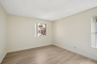 Empty room with wooden floor and a window.