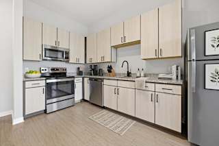 A kitchen with wooden cabinets and stainless steel appliances.