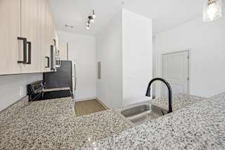 A kitchen with granite countertops and a sink.