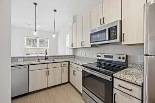 A kitchen with a stove, oven, and refrigerator.