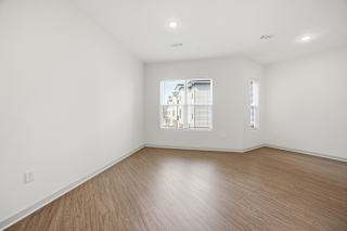 Empty room with wooden floor and white walls.