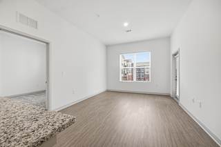A room with a marble countertop and wooden flooring.