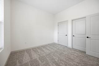 A room with a carpet that has the letter A on it.