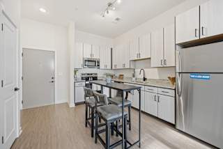 A kitchen with a table and chairs in the middle of the room.