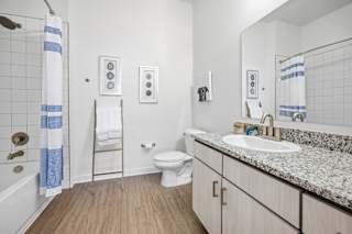 A bathroom with a toilet, sink, and shower.