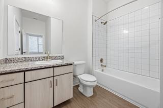 A white bathroom with a toilet, sink, and bathtub.