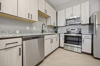 A kitchen with white cabinets and stainless steel appliances.