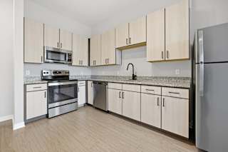 A kitchen with wooden cabinets and stainless steel appliances.