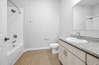 A white bathroom with a sink, toilet, and bathtub.