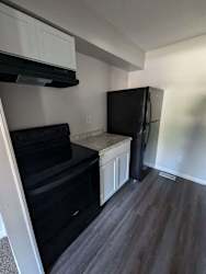 a kitchen with a refrigerator and a stove and a microwave