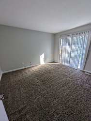 an empty living room with a sliding glass door