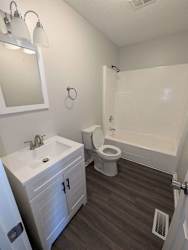 a bathroom with a toilet and a sink