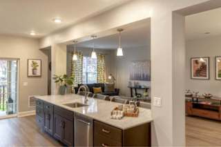 A modern kitchen with a large island and stainless steel appliances.
