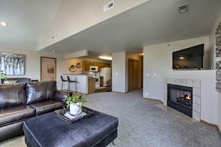 A living room with a fireplace and a couch. at Tranquility Pointe, Omaha, NE