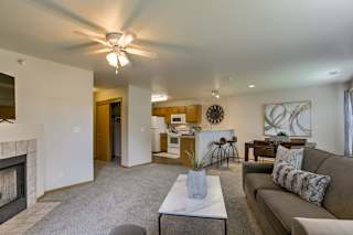 A living room with a fireplace and a couch. at Tranquility Pointe, Nebraska, 68164