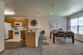 A kitchen with a dining table and chairs. at Tranquility Pointe, Omaha