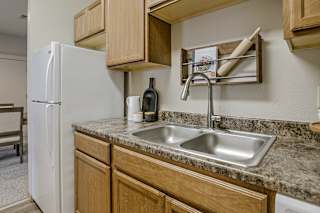 A kitchen with a white fridge and a granite counter top. at The Pointe, LaVista, Nebraska