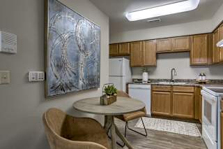 A kitchen with a table and a chair. at The Pointe, LaVista, Nebraska