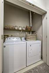 A white washer and dryer in a laundry room. at The Pointe, LaVista