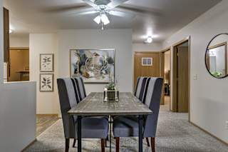 A dining room with a table and chairs. at The Pointe, LaVista, Nebraska