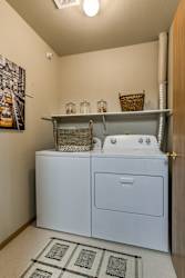 A laundry room with a washer and dryer. at The Pointe, LaVista, NE