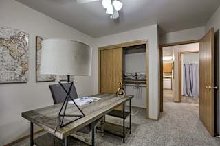A room with a desk and a lamp. at The Pointe, Nebraska