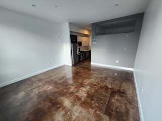 Open living area with polished concrete flooring at 68 Beale Apartments, Quincy, 02169