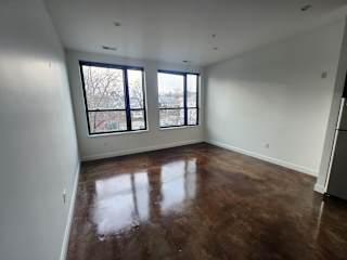 Spacious studio with polished concrete floors and corner windows at 68 Beale Apartments, Quincy