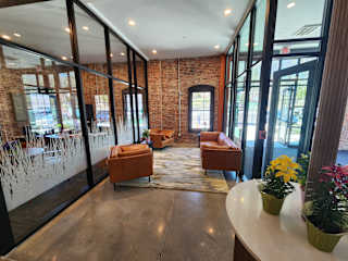 A room with a brick wall and a glass wall.
