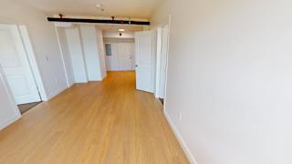 Empty apartment interior with hardwood flooring at Bostonian Shoe Lofts Apartments, Whitman, Massachusetts