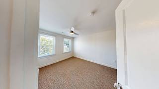 Carpeted bedroom with ceiling fan and natural light at Bostonian Shoe Lofts Apartments, Whitman, 02382