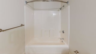 White tub surround with curved shower rod at Bostonian Shoe Lofts Apartments, Whitman, MA