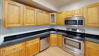 Kitchen with granite countertops and stainless steel appliances at Bostonian Shoe Lofts Apartments, Massachusetts, 02382