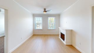 Unfurnished living space with corner fireplace and windows at Bostonian Shoe Lofts Apartments, Whitman, MA