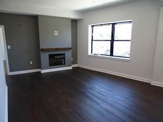 A room with a fireplace and a window.