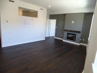 A room with a fireplace and a drawing on the wall.