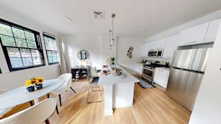 A modern kitchen with a dining table and chairs.