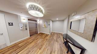 Elevator lobby with decorative lighting and wood flooring 1 at Bostonian Shoe Lofts Apartments, Massachusetts