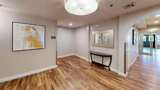 Hallway with artwork and console table at Bostonian Shoe Lofts Apartments, Whitman, MA