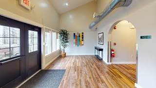 Building entrance with exit sign and wood floors at Bostonian Shoe Lofts Apartments, Whitman, 02382
