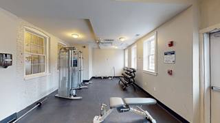 Fitness center with cable machine and free weights at Bostonian Shoe Lofts Apartments, Whitman, MA 02382