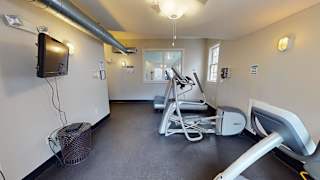 Gym with cardio equipment and wall mounted tv at Bostonian Shoe Lofts Apartments, Whitman, 02382