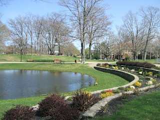 Park with pond curved garden beds and benches 1 at Bostonian Shoe Lofts Apartments, Whitman